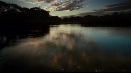 Clouds Reflected in Lake at Sunrise Time Lapse