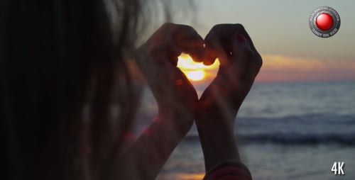 Heart Shape Created with Hands on the Beach