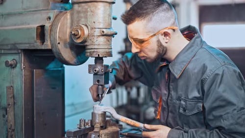 Engineer Working on Industrial Machine in Factory