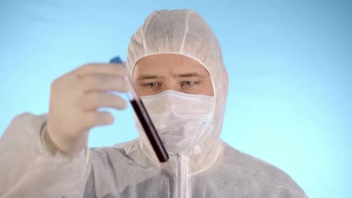 Scientist in Protective Suit with Vial of Blood