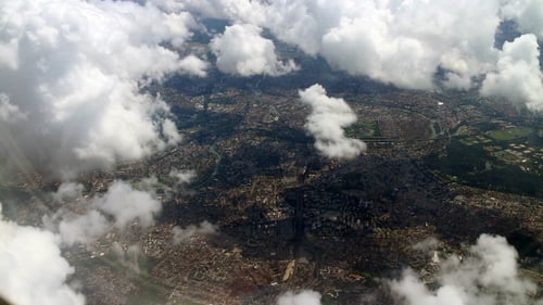Airplane Flying over City and Clouds 851