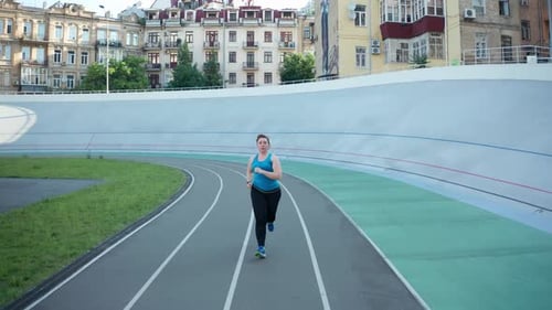 Drone Shot of Plus Size Female Jogging at Stadium