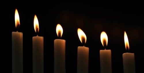 Candle Flames Burning Brightly in the Darkness