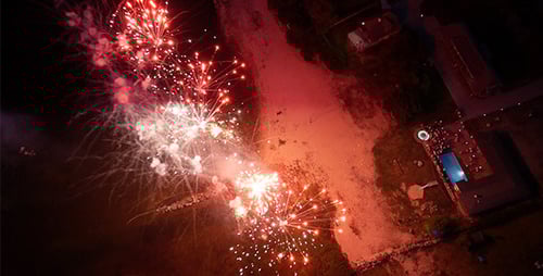 Aerial Fireworks Display Over Coastline at Night