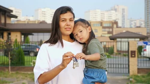Woman and Child Hold Keys to New House