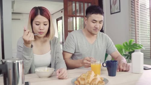 Couple Enjoys Breakfast Together at Kitchen Table