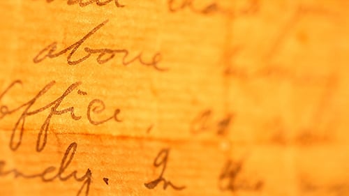Close Up of Handwritten Letter on Orange Paper