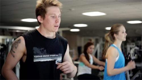 People exercising on treadmills at the gym