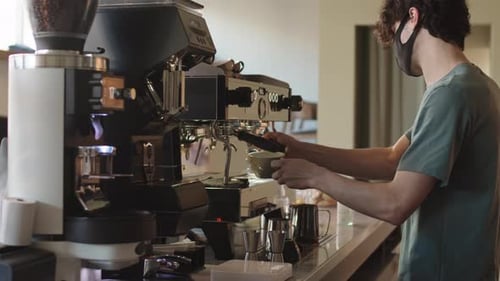 Barista Making Espresso With Professional Coffee Machine
