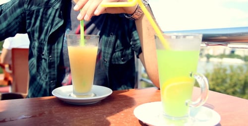 Man With Drinks on Table at Outdoor Cafe
