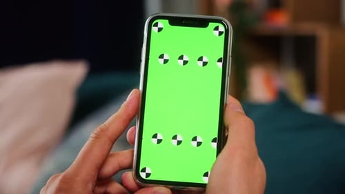 Closeup of a Man Hand Holding Green Mockup Chroma Key Screen Smartphone
