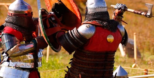 Medieval Reenactors Fighting With Swords And Axes