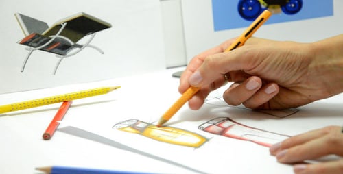 Designer Colors a Sketch with a Colored Pencil