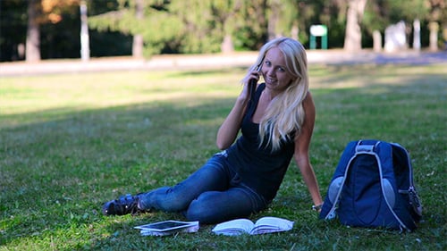 Woman Talking on Phone While Sitting in Park
