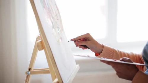 Artist with Palette Knife Painting at Art Studio