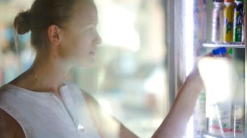 Woman Choosing Milk At The Shop