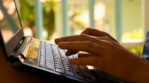 Hands Typing on Laptop Keyboard, Close Up