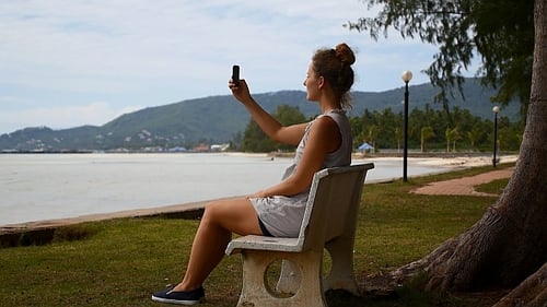Woman Taking Photo by Tropical Island Beach
