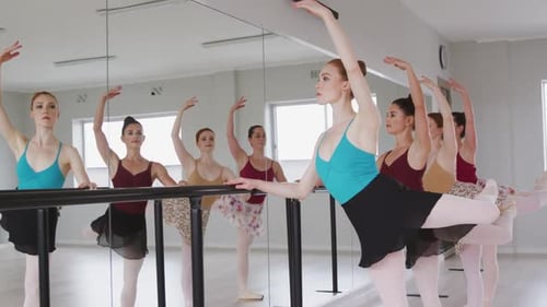 Ballet Dancers Practicing Elegant Poses in Dance Studio