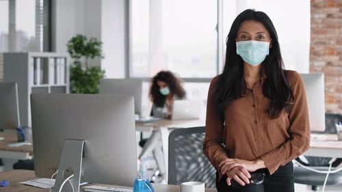 Confident Woman in Mask in Modern Office