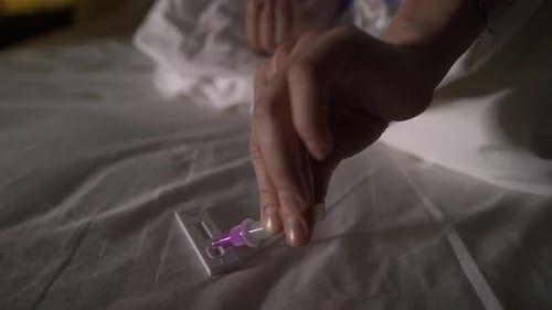 Macro View of Woman Making Express Covid19 Antigen Test Sitting on a Bed at Home