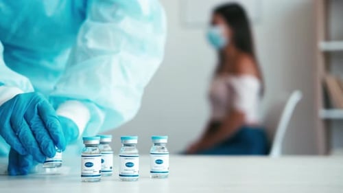 Medical Professional Prepares COVID-19 Vaccine for Patient