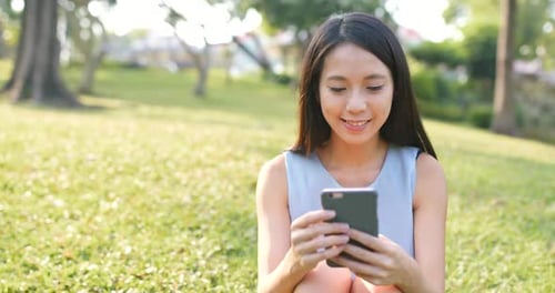 Woman Use of Smart Phone in The Park