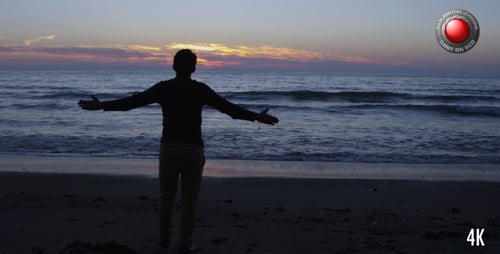 Adult Silhouette Welcoming Sunrise on the Beach