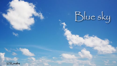 Clouds Drifting Slowly Across Bright Blue Sky