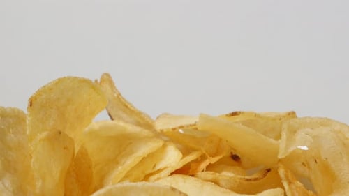 Vegetable crisps snack food background fried in oil slow tilt 4K 3840X2160 UltraHD footage - Popula