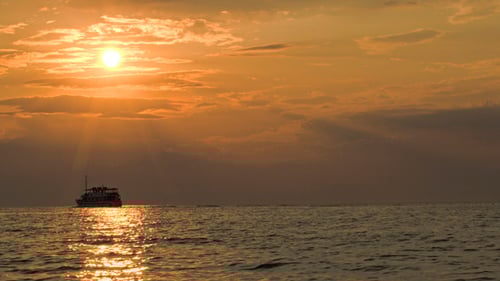Sailing Ship In Quiet Sea At Sunset