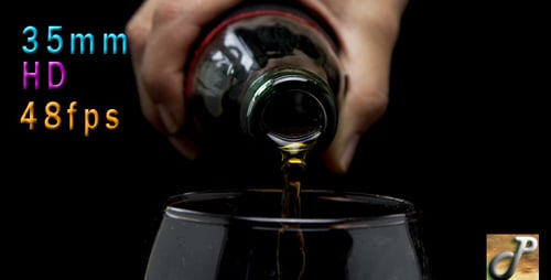 Amber Liquid Pouring into a Clear Glass