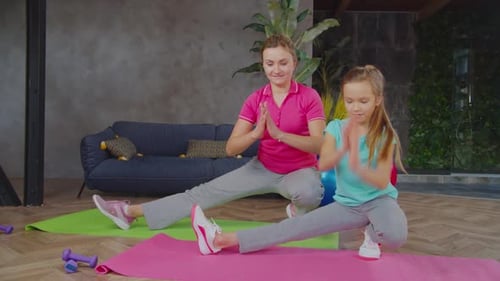 Woman and Child Stretching Together in Living Room