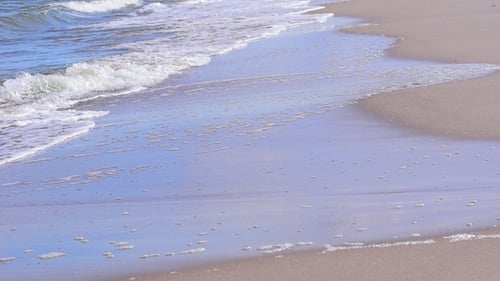 Waves Gently Rolling onto a Sandy Beach