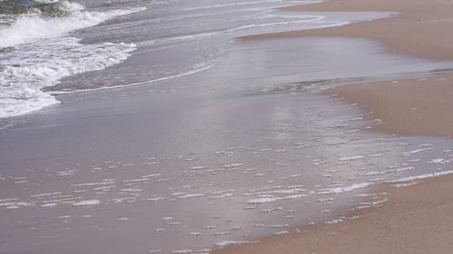 Gentle Ocean Waves on Sandy Beach Shoreline