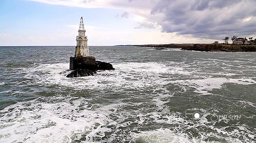 Lighthouse Standing Strong in Rough Seas