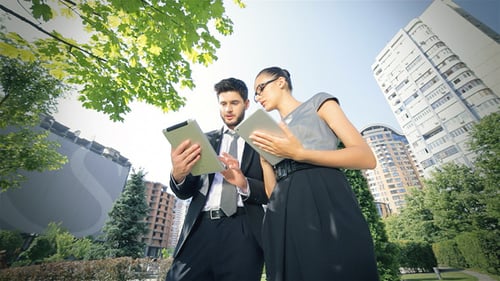 Business Professionals Using Tablets Outdoors in the City