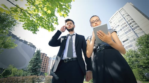 Professionals Using Tech in Urban Setting