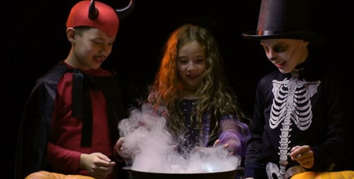 Children Make Halloween Potion Together in Costumes