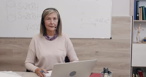 Woman Teaching Math Online in Home Office