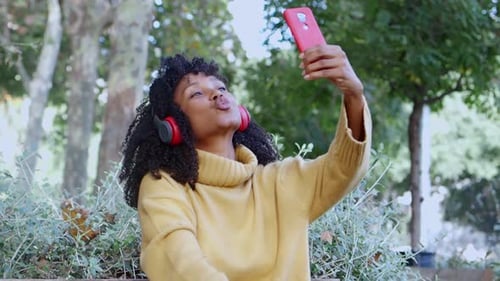 Happy Woman Taking Selfie in a Green Park