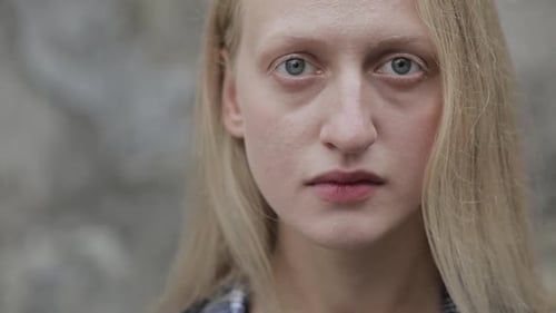 Portrait of Beautiful Woman Looking To Camera with Serious Face While Standing Outside. Close Up