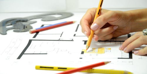 Architect Colors Blueprint With Pencil Close Up