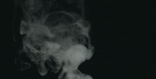 Abstract Gray Smoke Plumes Against Black Background