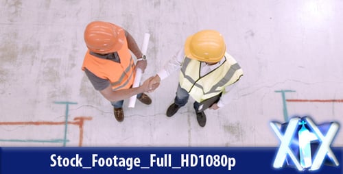 Construction Workers Shake Hands Over Blueprints