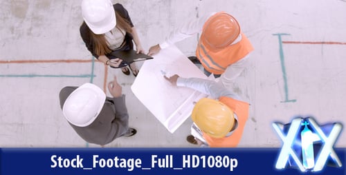 Aerial View of Engineers Discussing Blueprint in Urban Setting