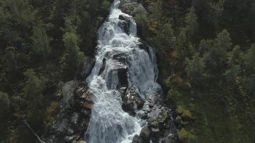 Waterfall, Rocks and Green Trees in Norway