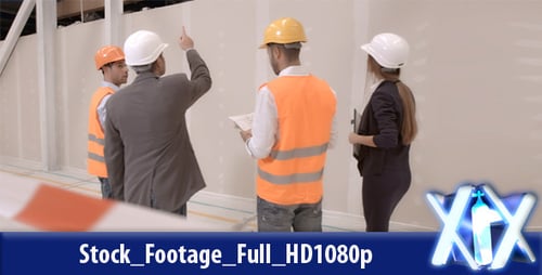 Construction Team Discussing Plans in Urban Building