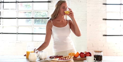 Woman Preparing Breakfast in a Sunny Home Kitchen