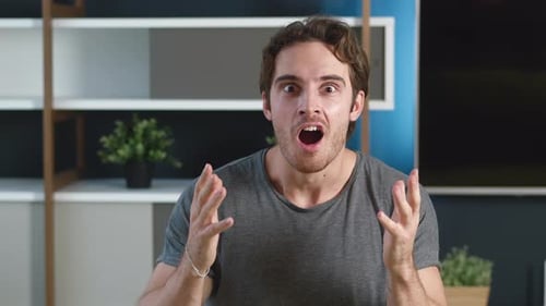 Surprised young man reacts with open mouth